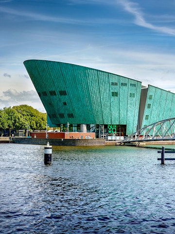 NEMO Science Museum in Amsterdam with its distinctive green architecture by the water.