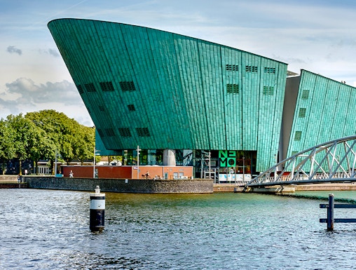 NEMO Science Museum in Amsterdam with its distinctive green architecture by the water.