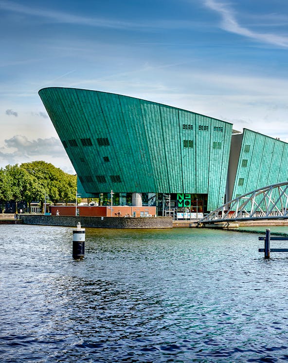 NEMO Science Museum in Amsterdam with its distinctive green architecture by the water.