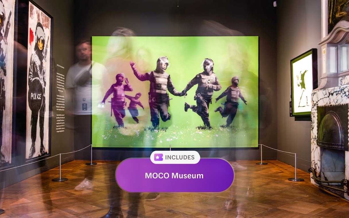 MOCO Museum Amsterdam art exhibit with vibrant green artwork and visitors.