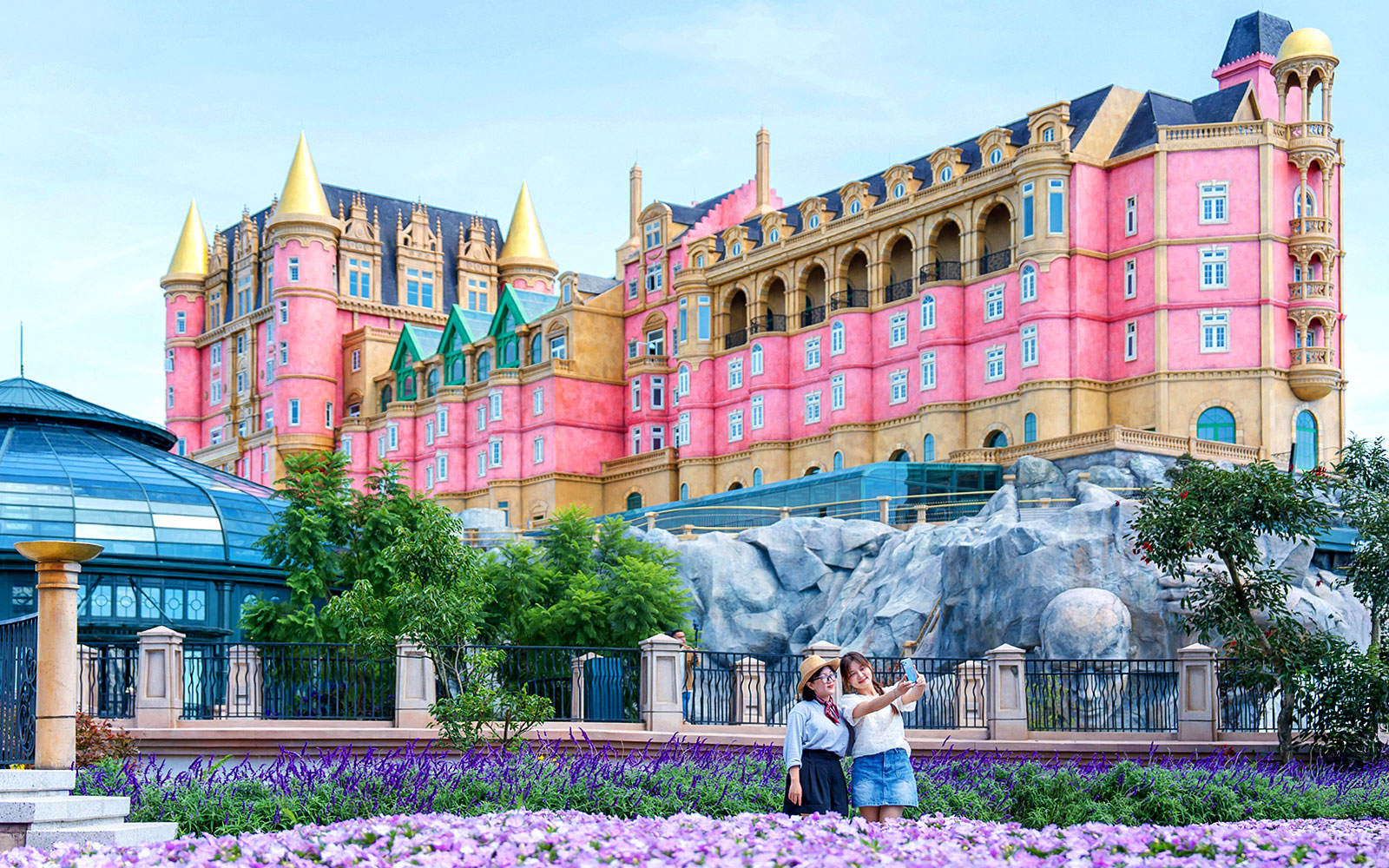 Tourist taking a photo in front of Luna Castle, Ba Na Hills, Vietnam.