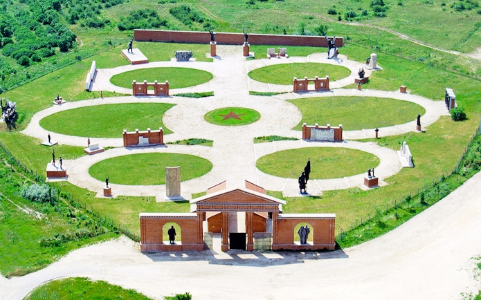 Aerial view of Memento Park in Budapest featuring statues and circular pathways.