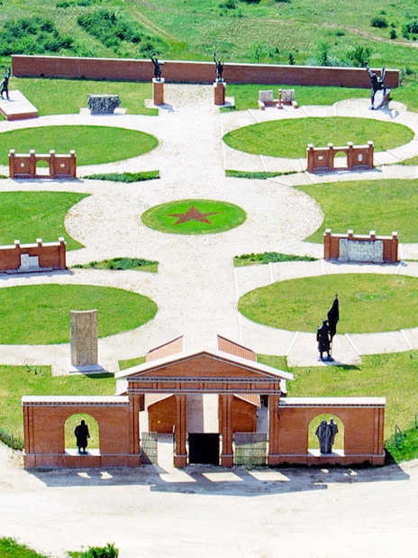 Aerial view of Memento Park in Budapest featuring statues and circular pathways.