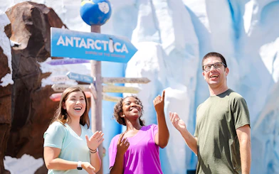 Visitors enjoying Antarctica realm at SeaWorld Orlando with icy backdrop.