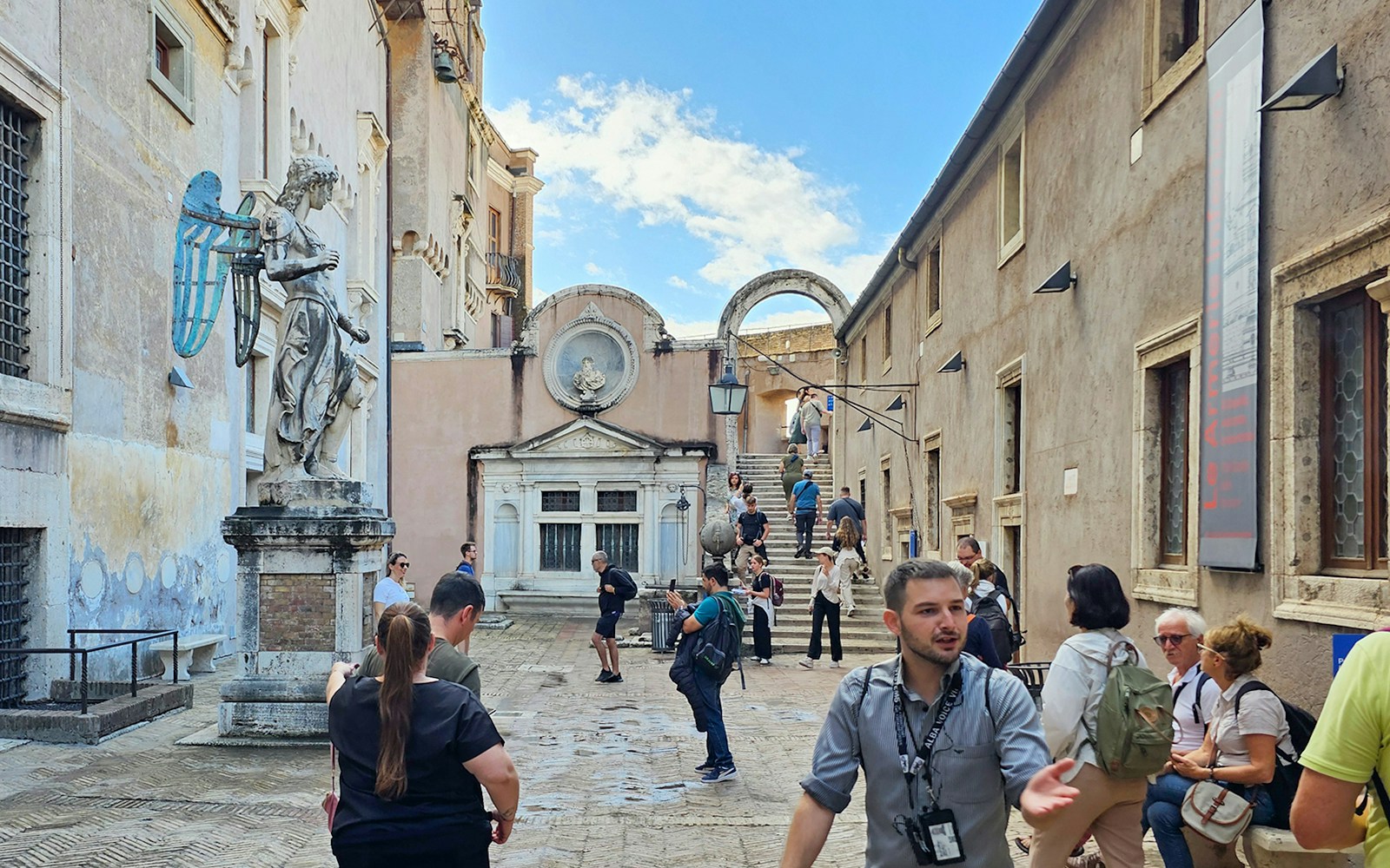 Visitors exploring the courtyard of Castel Sant'Angelo, Rome.