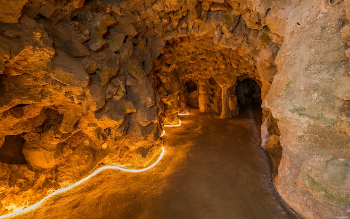 Underground tunnel with stone walls at Quinta da Regaleira, Lisbon.