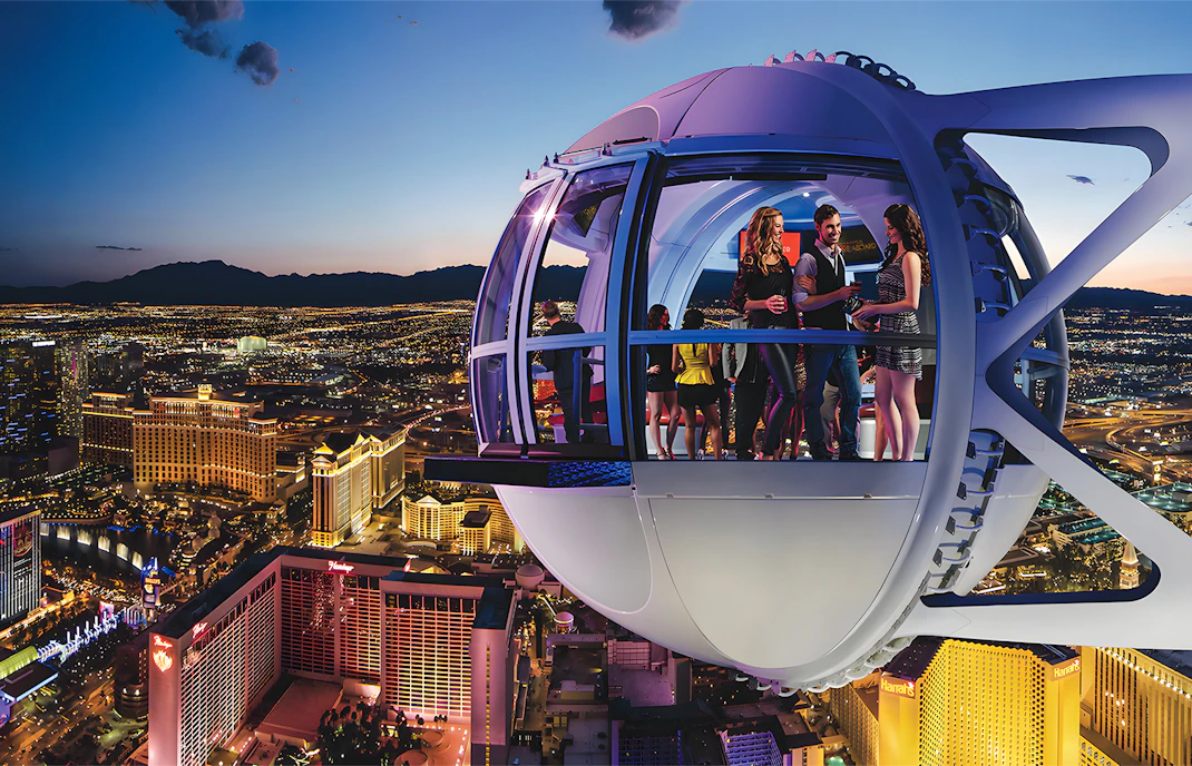 High Roller Wheel capsule overlooking Las Vegas Strip at dusk.
