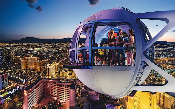 High Roller Wheel capsule overlooking Las Vegas Strip at dusk.
