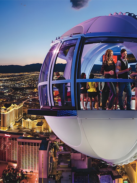 High Roller Wheel capsule overlooking Las Vegas Strip at dusk.