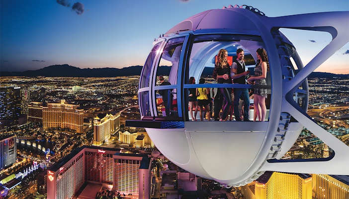 High Roller Wheel capsule overlooking Las Vegas Strip at dusk.