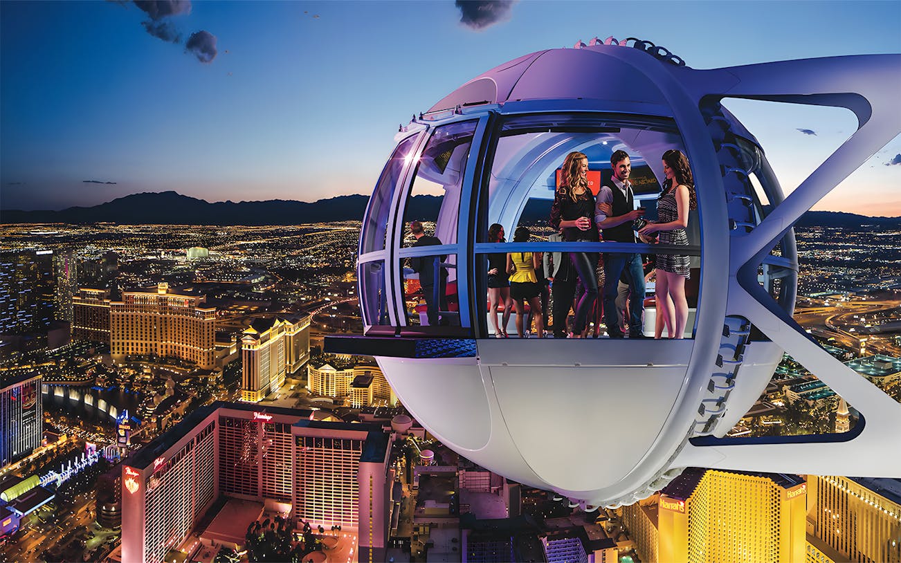 High Roller Wheel capsule overlooking Las Vegas Strip at dusk.