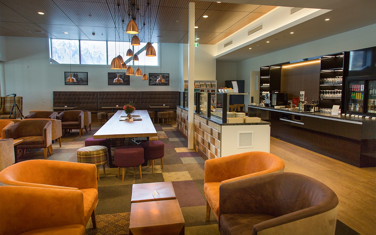 Plaza Premium Lounge seating area with modern decor and refreshments counter.