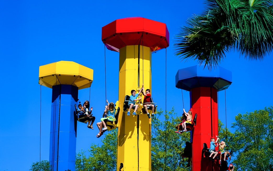 Kids enjoying the Kid Power Tower ride at LEGOLAND Theme Park, Florida.