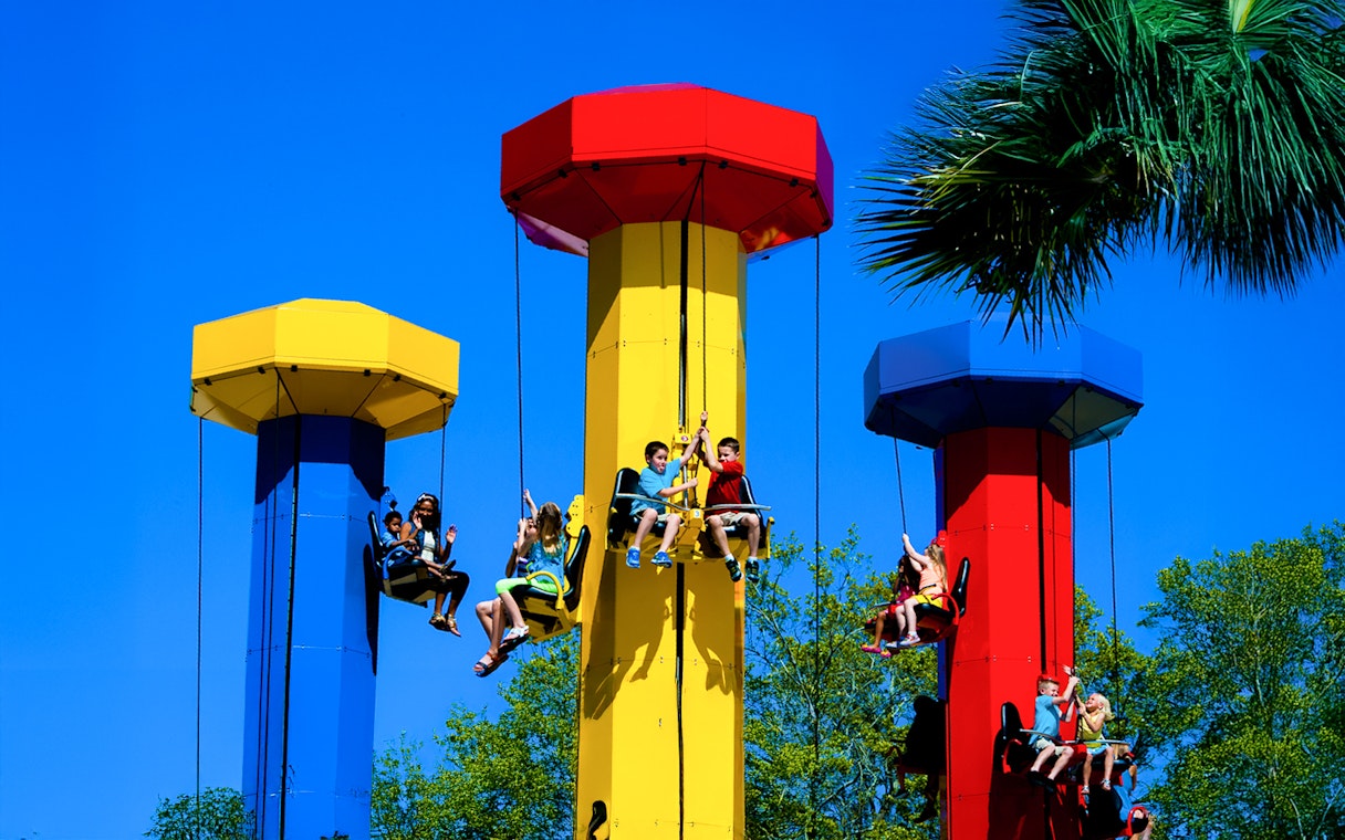 Kids enjoying the Kid Power Tower ride at LEGOLAND Theme Park, Florida.