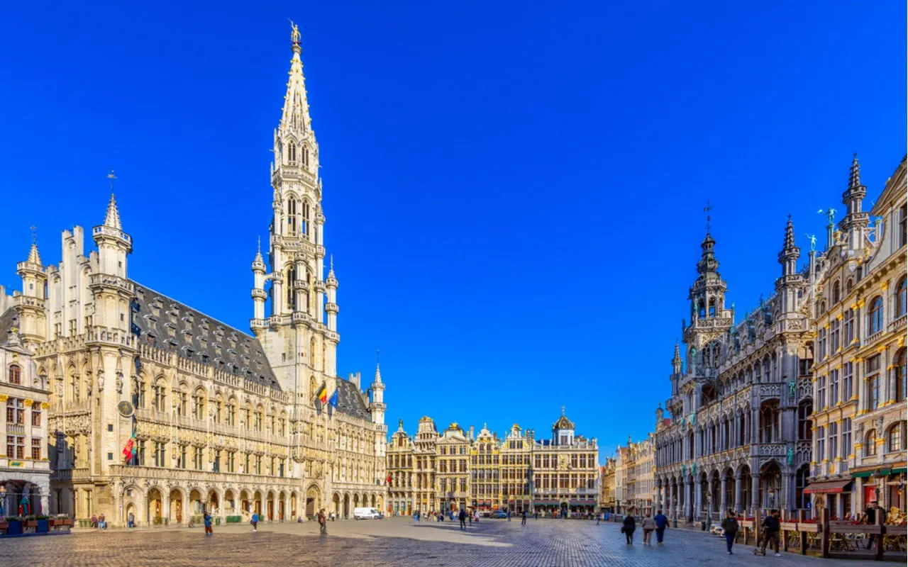 Grand Place in Brussels during the day, featuring historic buildings and tourists exploring.