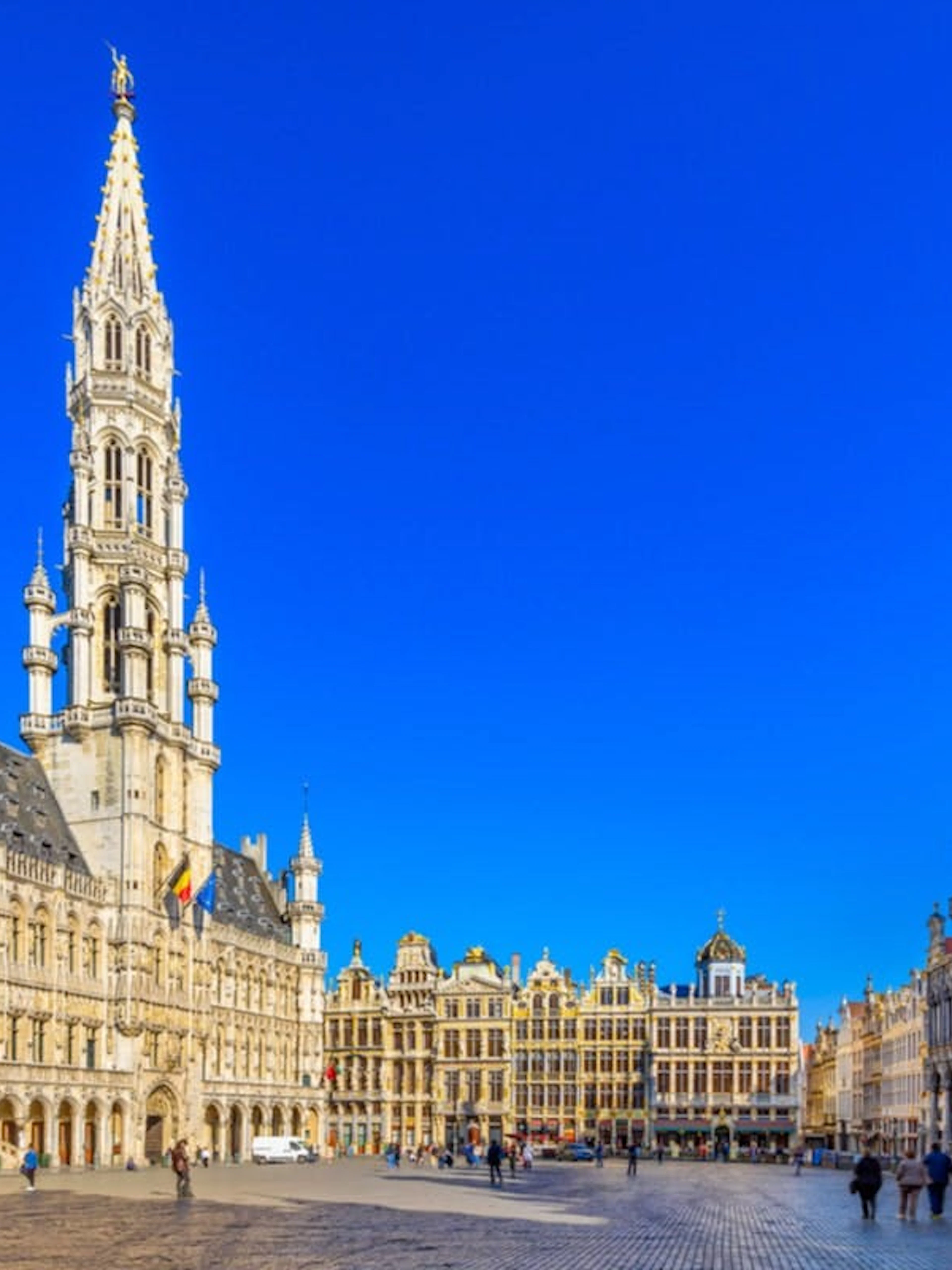 Grand Place in Brussels during the day, featuring historic buildings and tourists exploring.