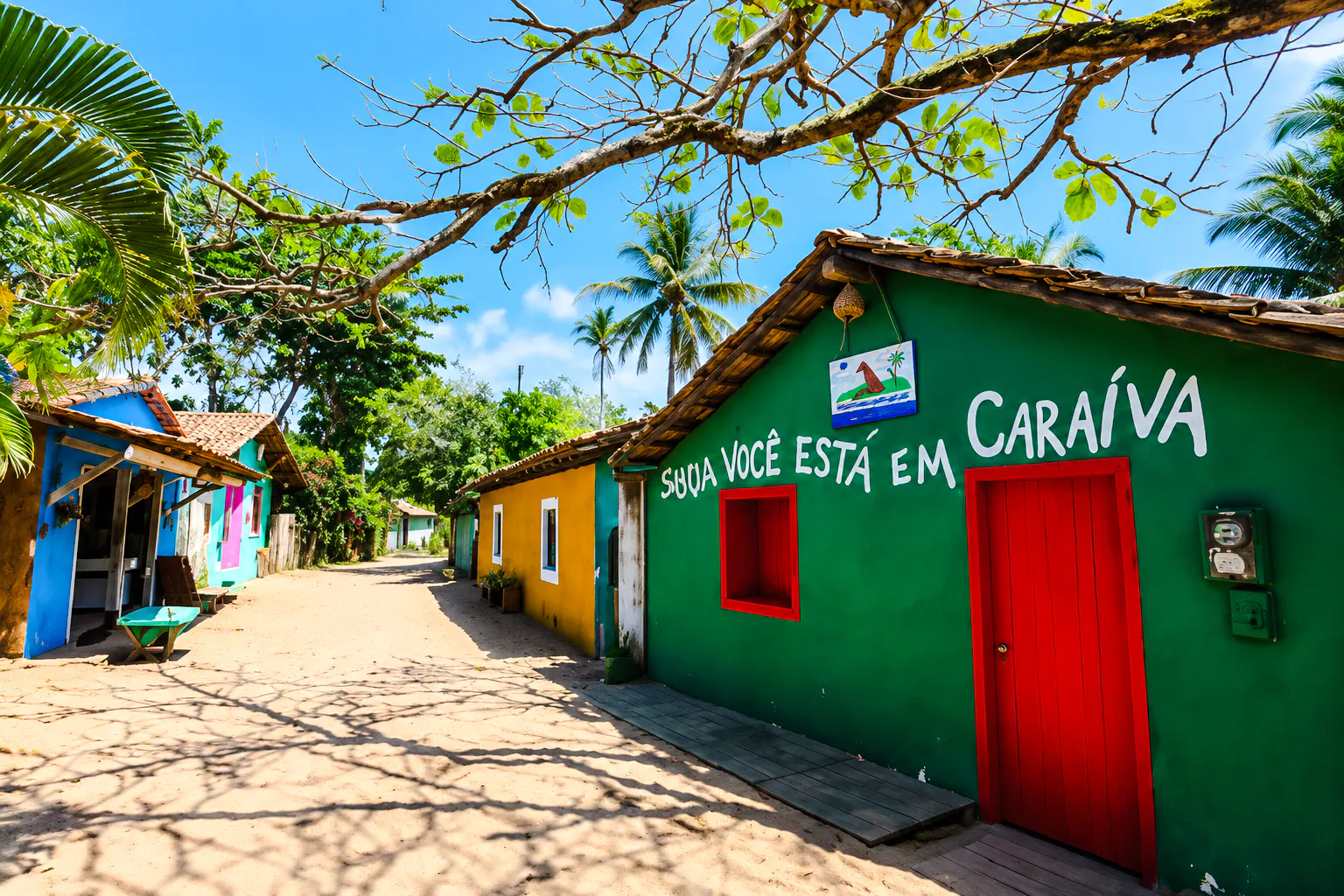 Colorful houses on a sandy street in Caraíva, Porto Seguro, Brazil.