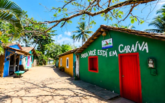 Colorful houses on a sandy street in Caraíva, Porto Seguro, Brazil.