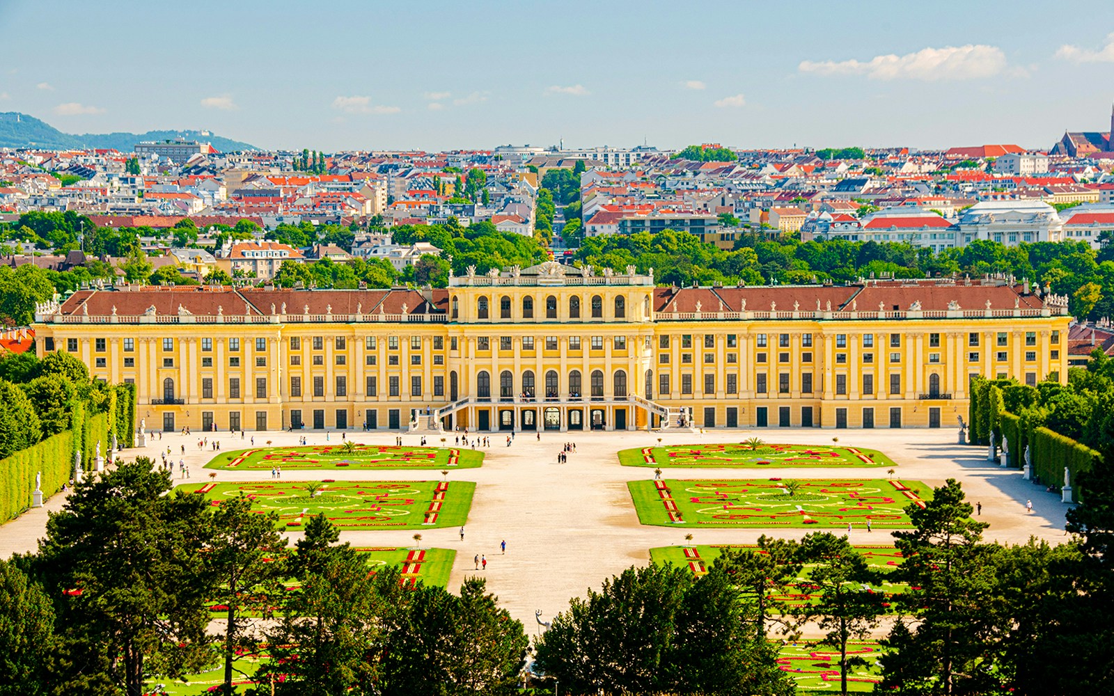 Schönbrunn Palace in Vienna with gardens and cityscape in the background.