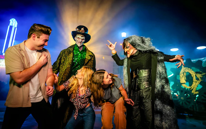 Guests interacting with costumed performers in Halloween Haunt zones at Dorney Park.