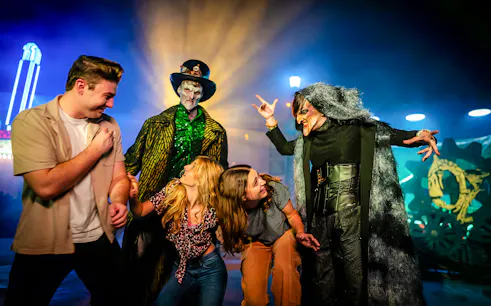 Guests interacting with costumed performers in Halloween Haunt zones at Dorney Park.