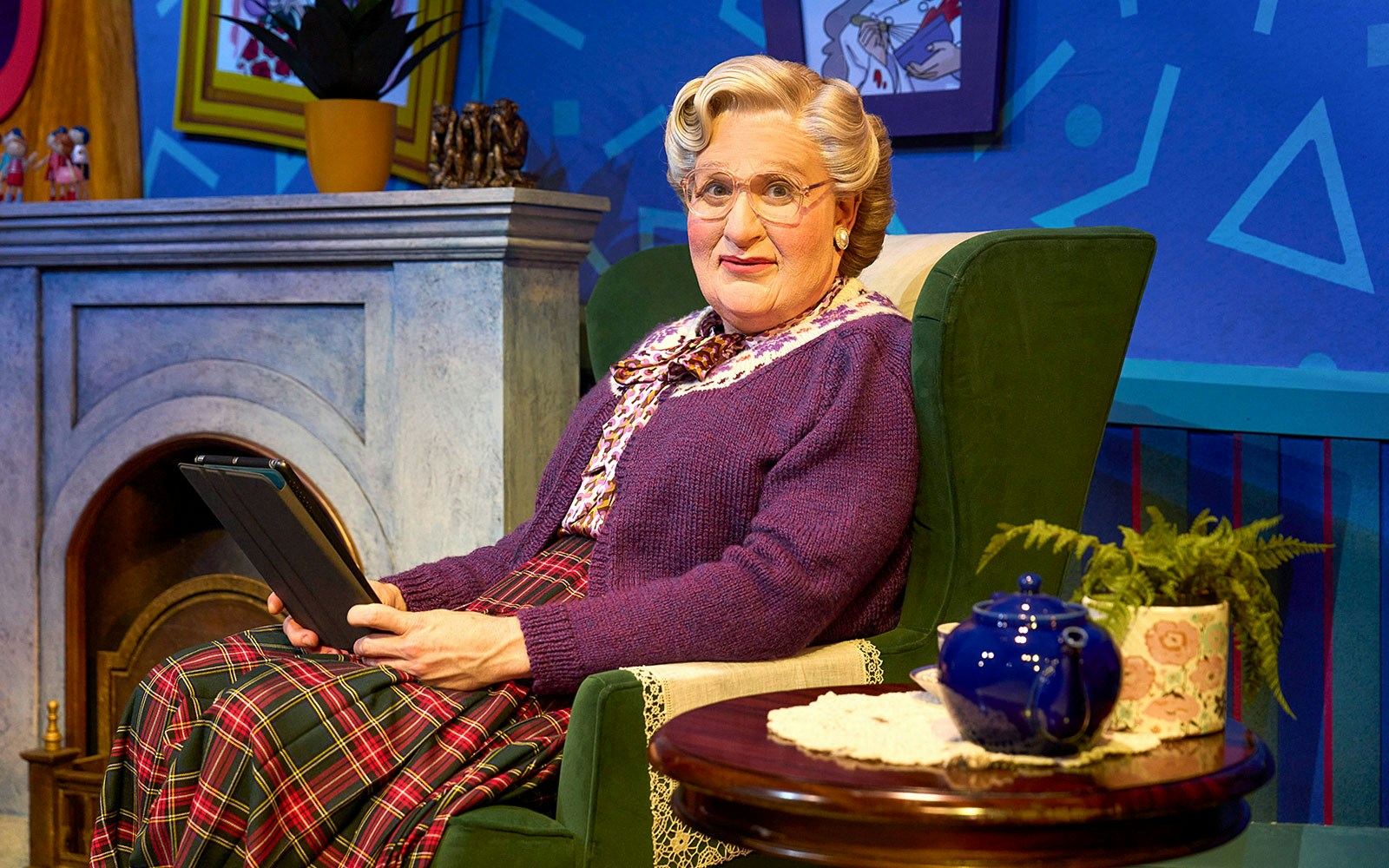 Person in a cozy living room setting holding a tablet, associated with Mrs. Doubtfire.