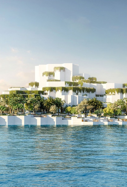 Aerial view of National History Museum Abu Dhabi with tiered white structures and greenery by the water.