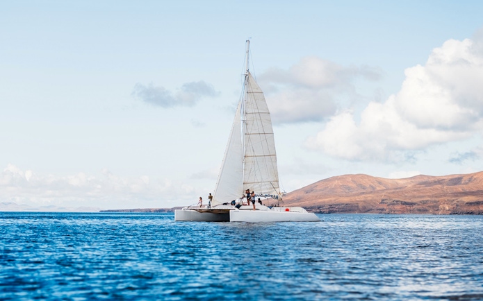 Tourists on a catamaran in Lanzarote waters, heading to watch whales and dolphins.