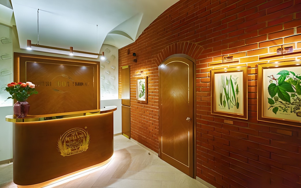 Spa Beerland reception area with brick walls and botanical artwork.