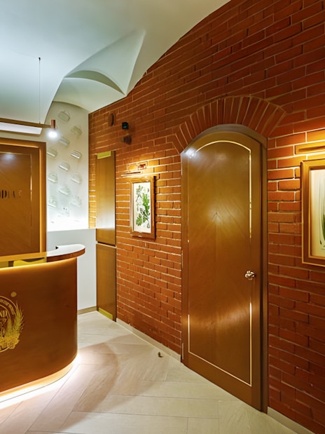 Spa Beerland reception area with brick walls and botanical artwork.