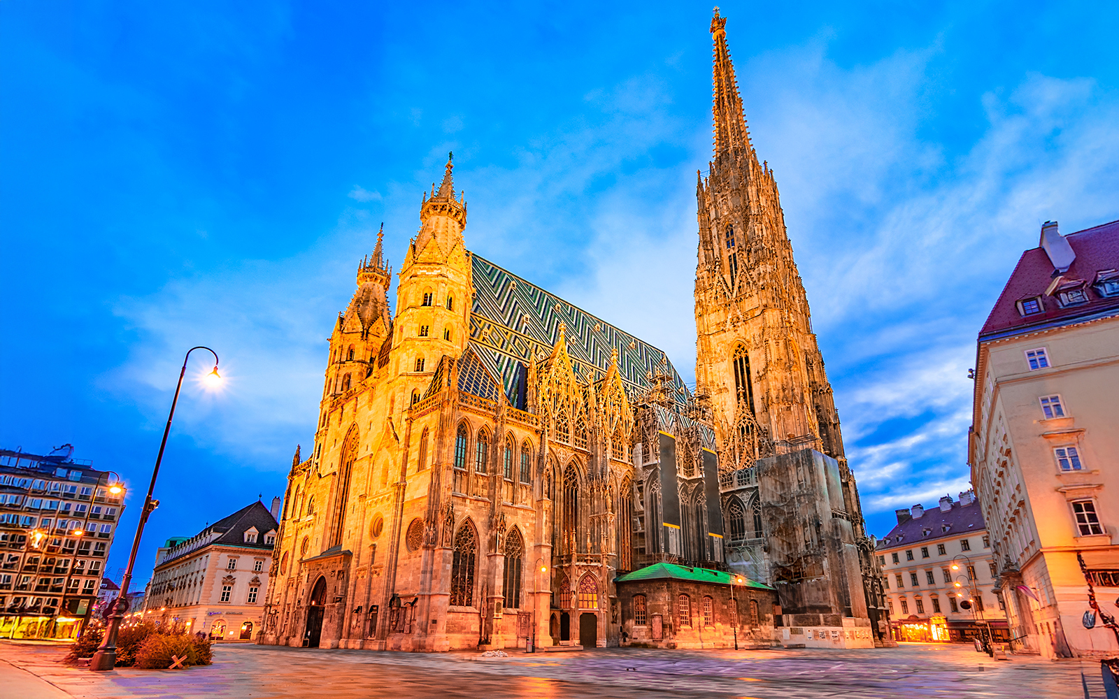 St. Stephen's Cathedral in Vienna at dusk with illuminated facade.