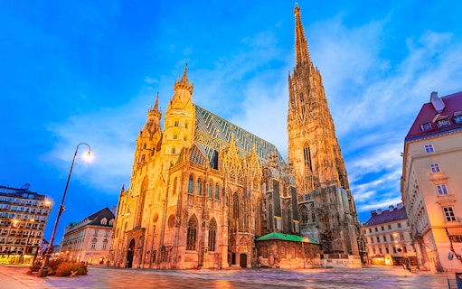 St. Stephen's Cathedral in Vienna at dusk with illuminated facade.