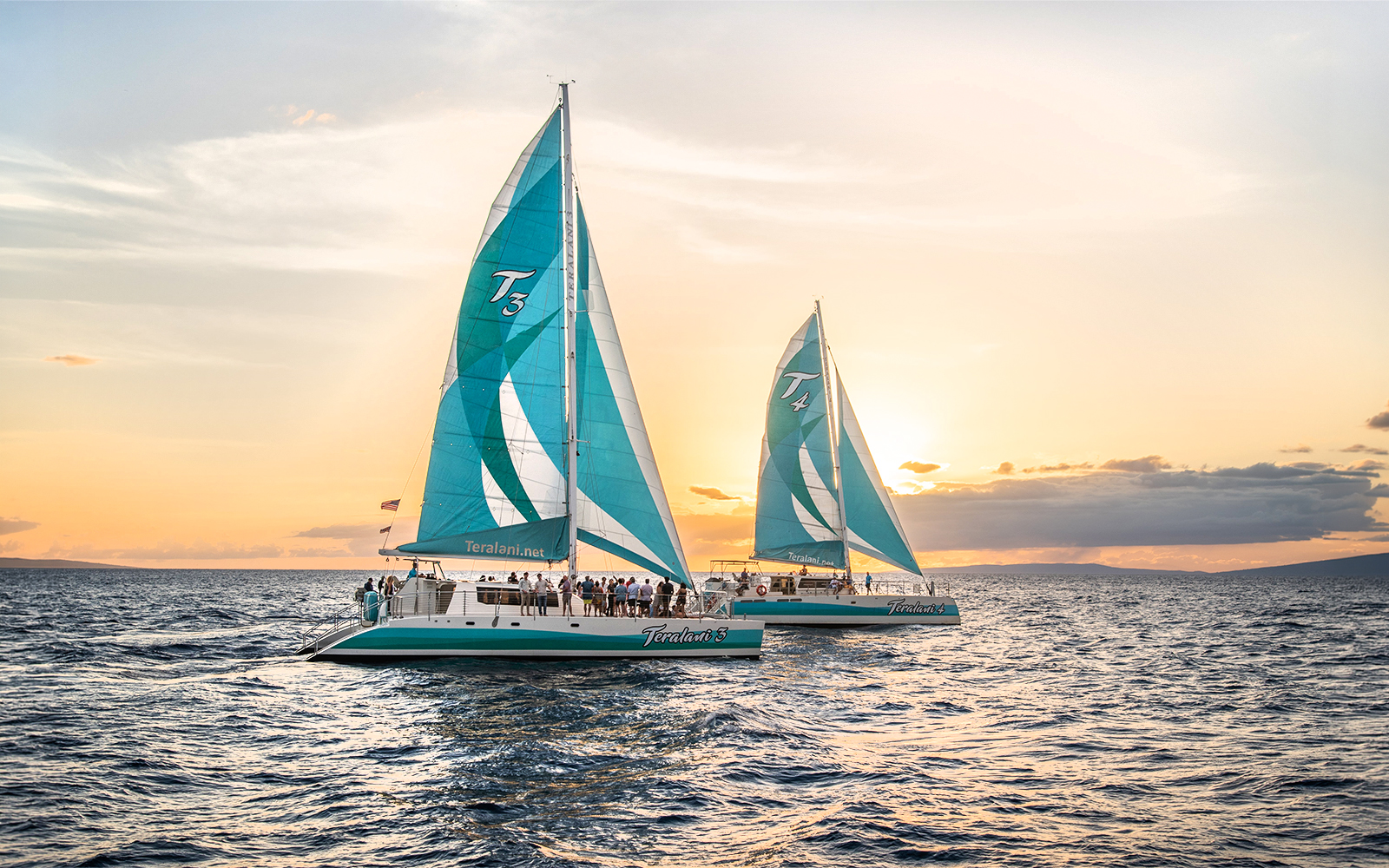 Sailboats on a luxury snorkel tour at sunset in Maui, Hawaii.