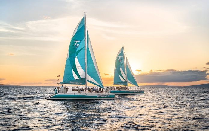 Sailboats on a luxury snorkel tour at sunset in Maui, Hawaii.