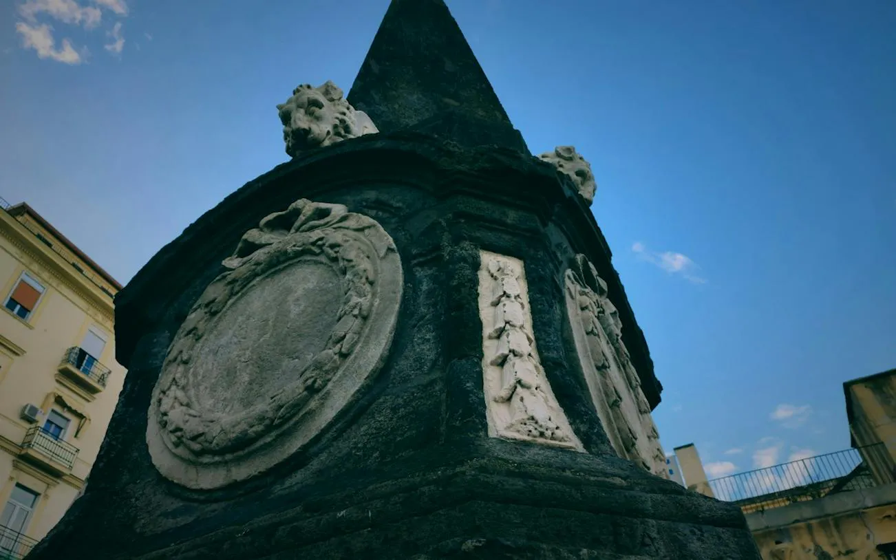 Stone monument detail in Naples, part of the Curse of Naples Mafia Secrets exploration game.