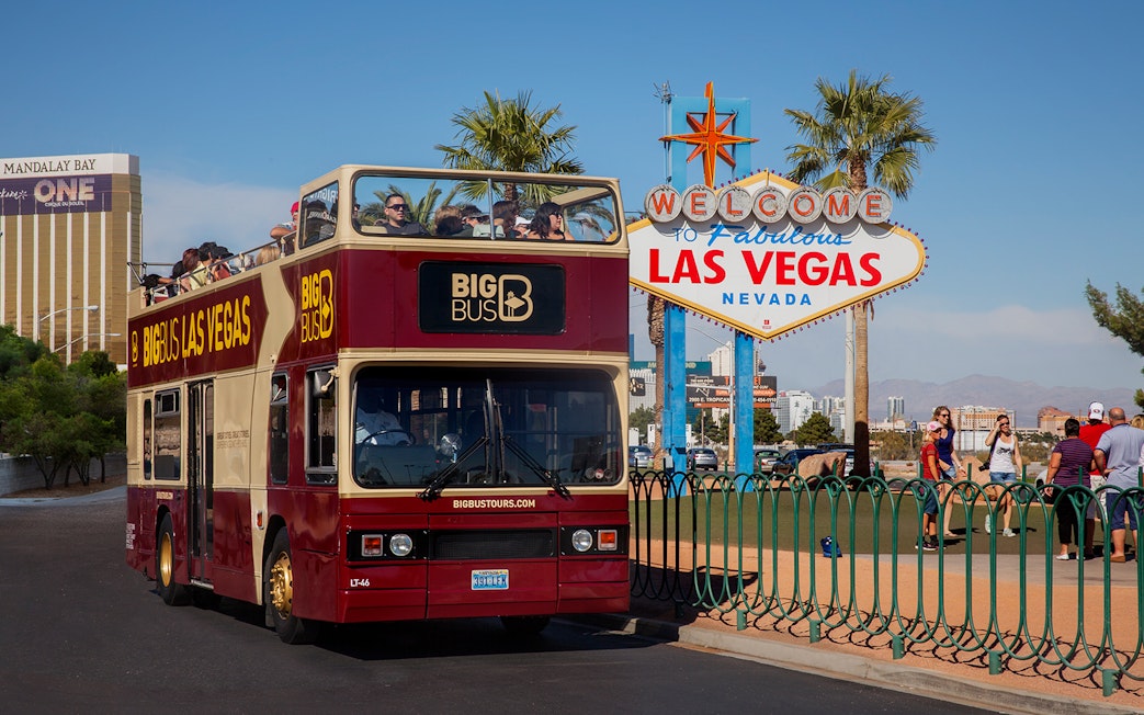 Open-top tour bus near the Welcome to Las Vegas sign, Nevada.