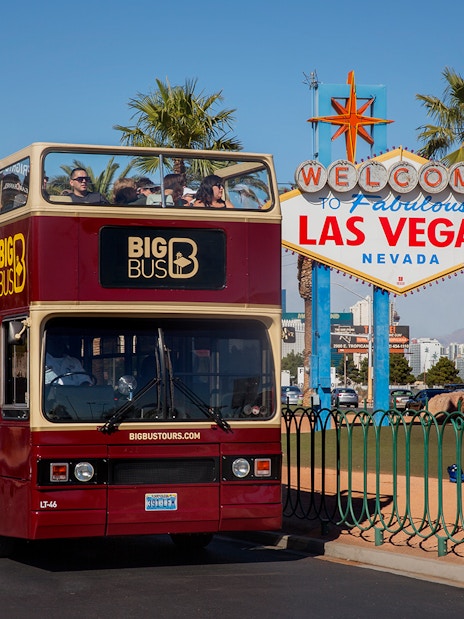 Open-top tour bus near the Welcome to Las Vegas sign, Nevada.