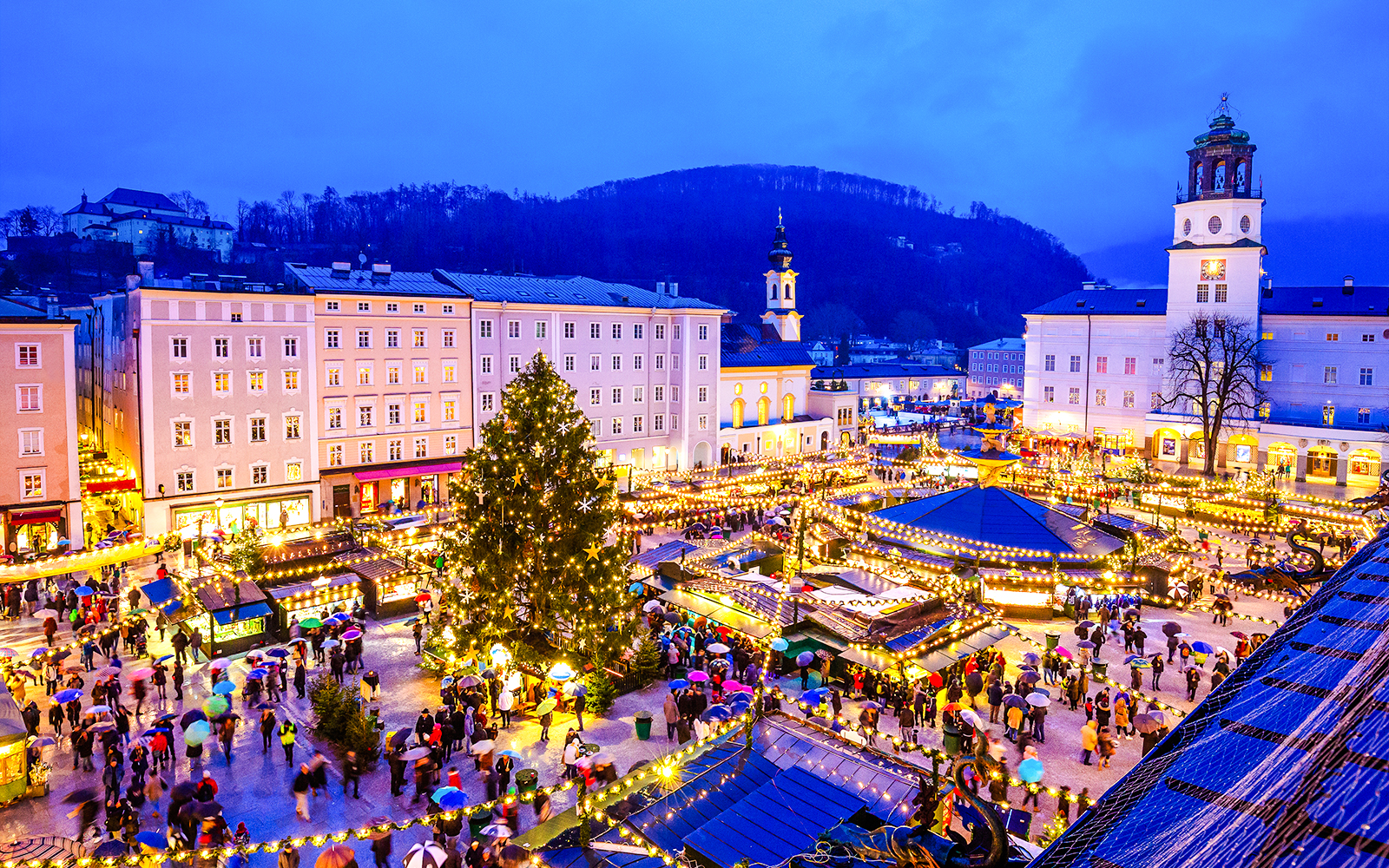 Salzburg Christmas Market with festive lights and crowds in Austria.