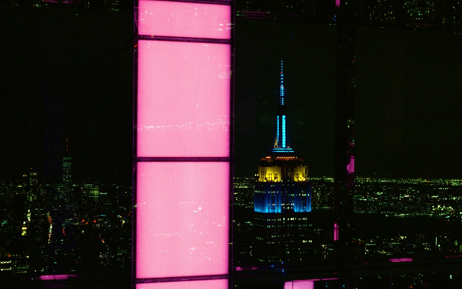 SUMMIT One Vanderbilt illuminated at night with city skyline views, New York City.