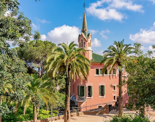 Park Guell Gaudi House Museum exterior with colorful mosaic tiles in Barcelona, Spain.