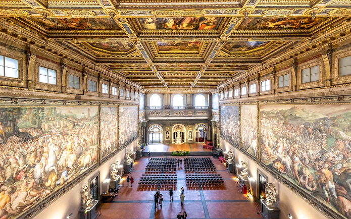 Palazzo Vecchio Hall of the Five Hundred with ornate ceiling and historic frescoes, Florence, Italy.