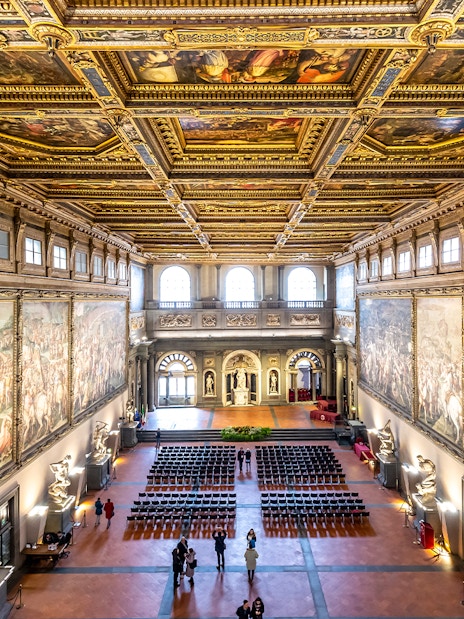 Palazzo Vecchio Hall of the Five Hundred with ornate ceiling and historic frescoes, Florence, Italy.