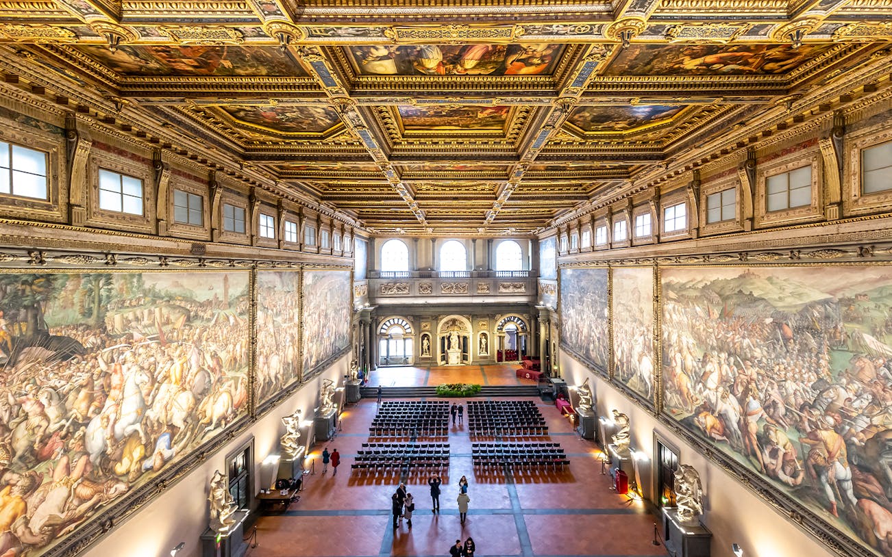 Palazzo Vecchio Hall of the Five Hundred with ornate ceiling and historic frescoes, Florence, Italy.