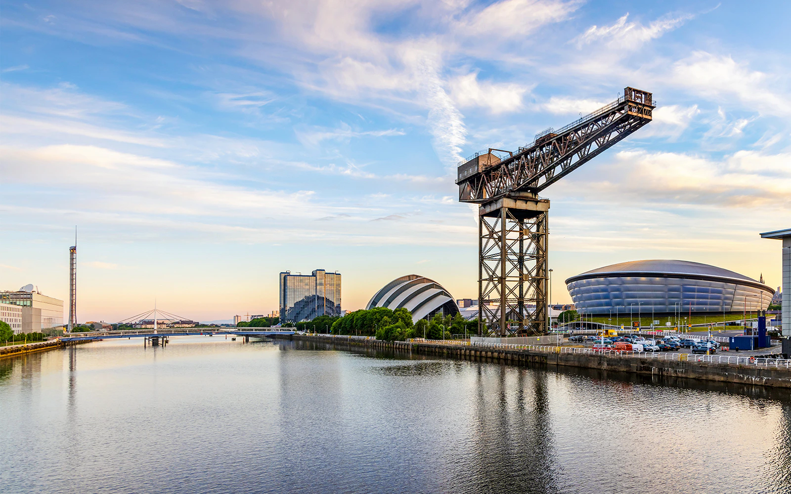 Finnieston Crane beside the River Clyde with Glasgow's modern architecture in the background.