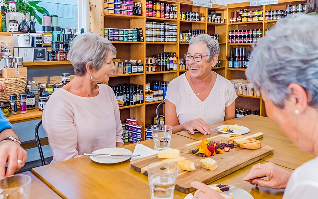 Visitors enjoying a cheese and wine tasting at Sunshine Coast Hinterland tour.