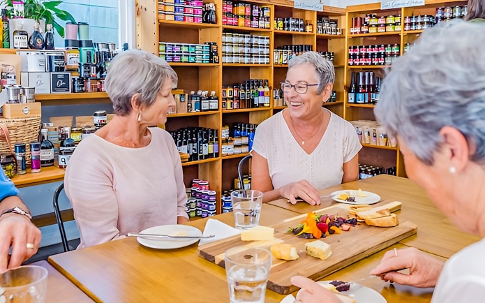 Visitors enjoying a cheese and wine tasting at Sunshine Coast Hinterland tour.