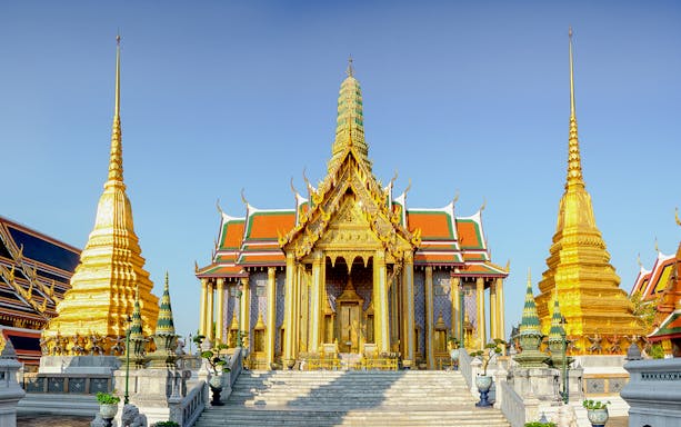 Wat Phra Kaew temple complex with golden spires, Bangkok, Thailand.