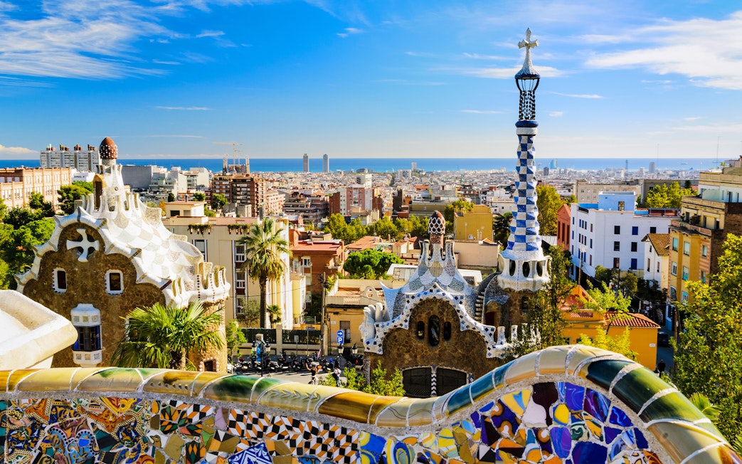 Park Güell mosaic terrace overlooking Barcelona cityscape, Spain.
