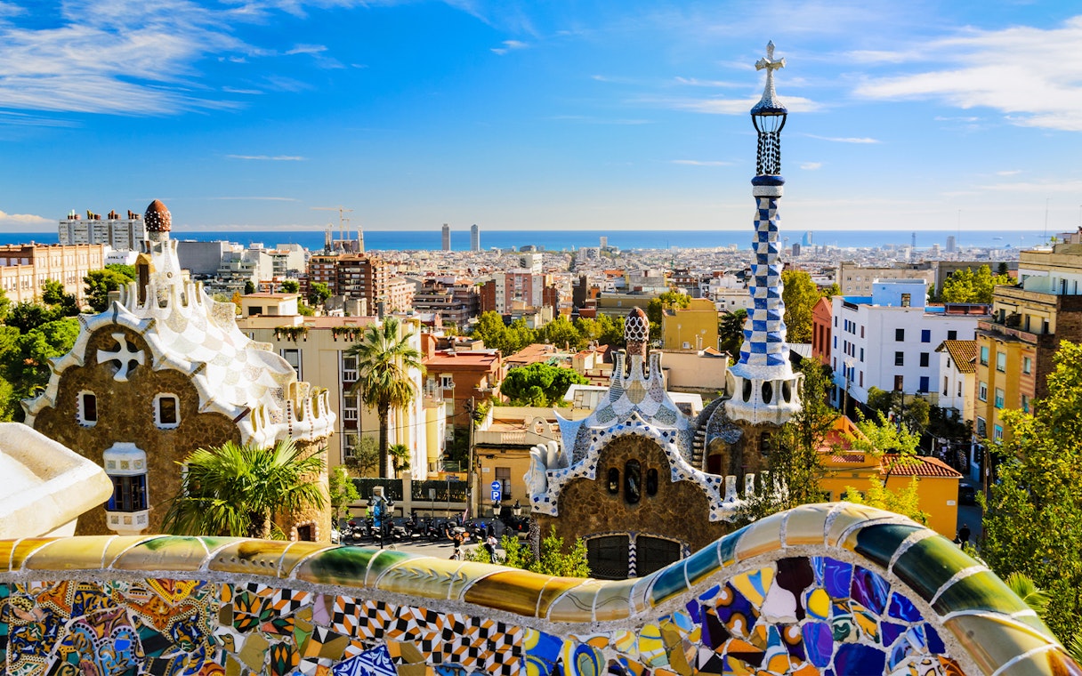 Park Güell mosaic terrace overlooking Barcelona cityscape, Spain.