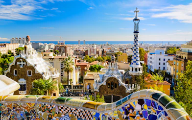 Park Güell mosaic terrace overlooking Barcelona cityscape, Spain.